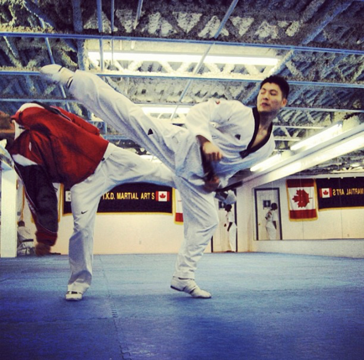 Steve Lee executing a high kick during Taekwondo training